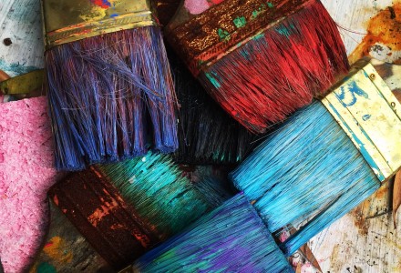 paint brushes with bright coloured paint